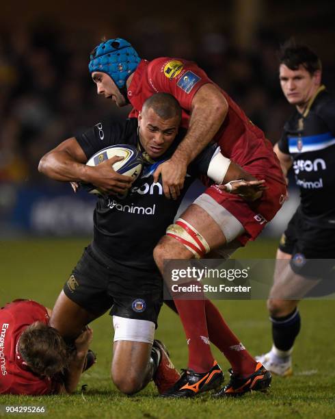 Bath centre Jonathan Joseph is stopped by Scarlewts forward Tadhg Bierne during the European Rugby Champions Cup match between Bath Rugby and...