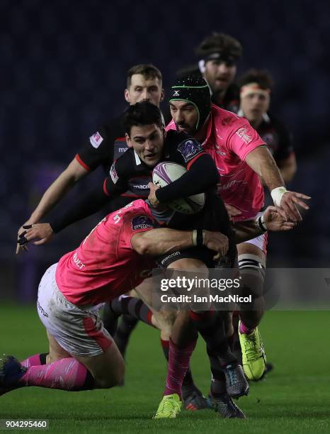 Sam Hidalgo-Clyne of Edinburgh Rugby is tackled by Matthieu Ugena of Stade Francais Paris during the European Rugby Challenge Cup match between...
