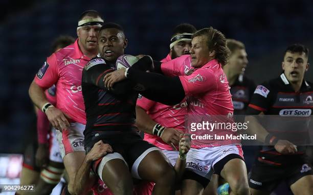 Viliame Mata of Edinburgh Rugby is tackled by Charl McLeod of Stade Francais Paris during the European Rugby Challenge Cup match between Edinburgh...