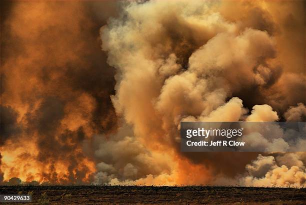 prairie fire burns  - prairie stock pictures, royalty-free photos & images