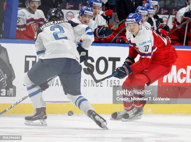 Ostap Safin of Czech Republic skates the puck up ice against Miro Heiskanen of Finland during the first period of play in the IIHF World Junior...