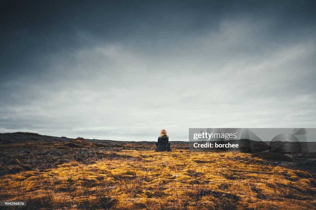 Woman Admiring The Volcanic Landscape In Iceland