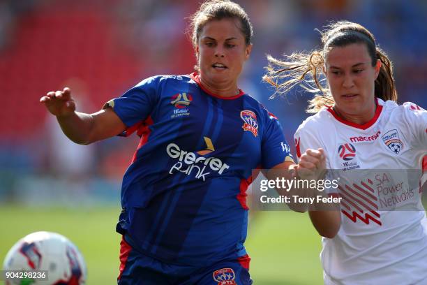 Katherine Stengel of the Jets contests the ball with Kathleen Naughton of the Adelaide during the round 11 W-League match between the Newcastle Jets...