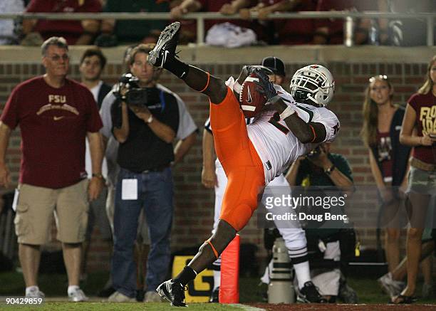 Graig Cooper of the Miami Hurricanes catches a 24-yard touchdown pass from in the fourth quarter against the Florida State Seminoles at Doak Campbell...