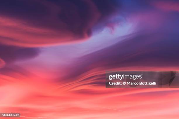 moody lenticular clouds at sunset - dramatic sky clouds stock pictures, royalty-free photos & images
