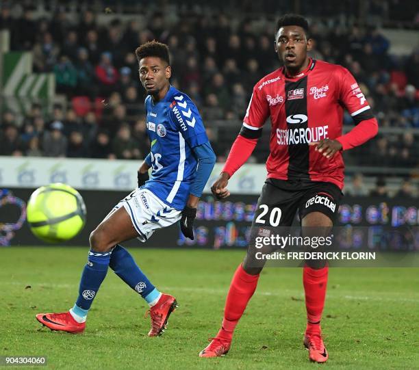 Guingamp's Cameroonian defender Felix Eboa Eboa vies with Strasbourg's Algerian forward Idriss Saadi during the French L1 football match between...
