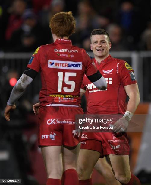 Scarlets player Scott Williams celebrates with try architect Rhys Patchell after scoring the bonus point fourth try during the European Rugby...