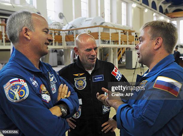 Canadian space tourist and founder of Cirque du Soleil Guy Laliberte , US astronaut Jeff Williams , and Russian cosmonaut Maxim Surayev chat during a...