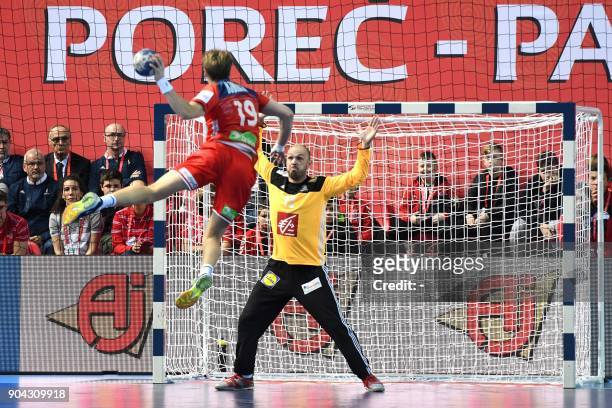 Norway's Kristian Bjornsen jumps to shoot the ball on goal in front of France's goalkeeper Vincent Gerrad during the preliminary round group B match...