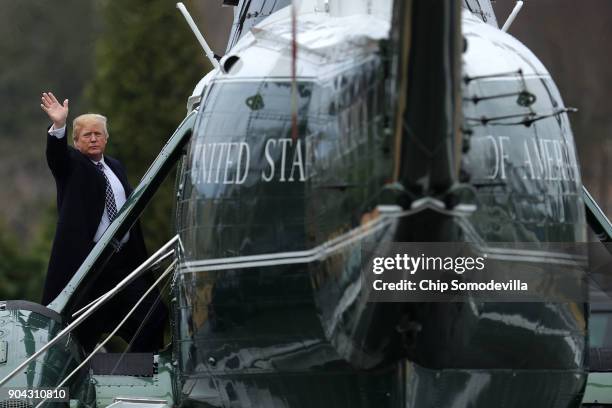 President Donald Trump waves to journalists as he boards Marine One on departure from Walter Reed National Military Medical Center following his...