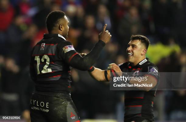 Junior Rasolea of Edinburgh Rugby is congratulated by team mate Damien Hoylandafter he scores his team's third try during the European Rugby...