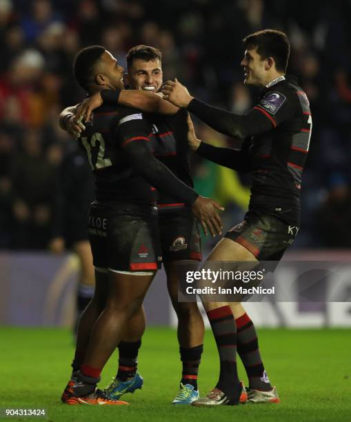 Junior Rasolea of Edinburgh Rugby is congratulated by team mate Damien Hoylandafter he scores his team's third try during the European Rugby...