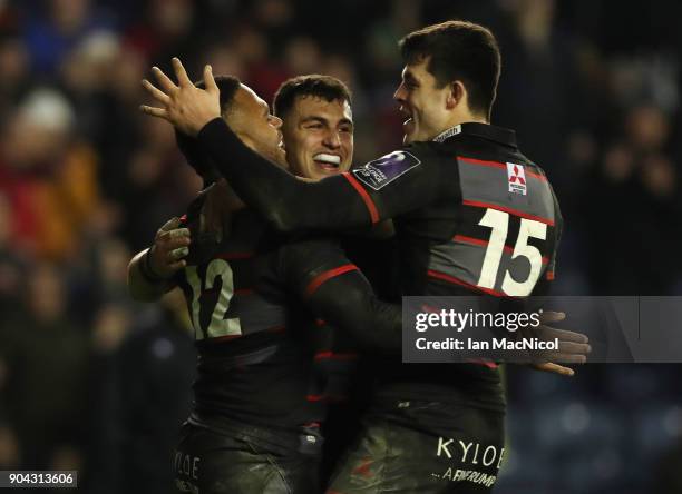 Junior Rasolea of Edinburgh Rugby is congratulated by team mate Damien Hoylandafter he scores his team's third try during the European Rugby...