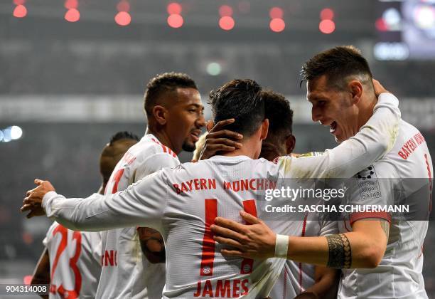 Bayern Munich's midfielder James Rodriguez celebrates after scoring with his teammates during the German First division Bundesliga football match...