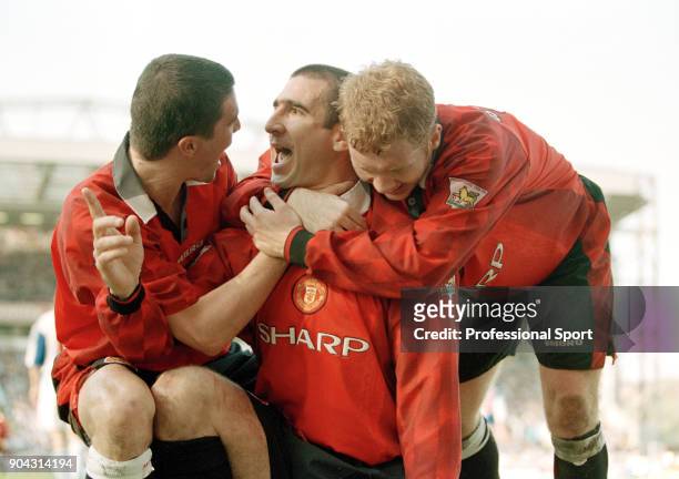 Eric Cantona of Manchester United is joined by teammates Roy Keane and Paul Scholes to celebrate scoring in the FA Carling Premiership match between...