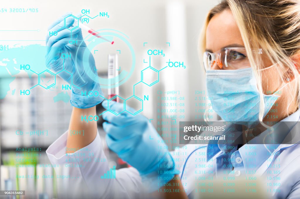 Young attractive female scientist researching in the laboratory
