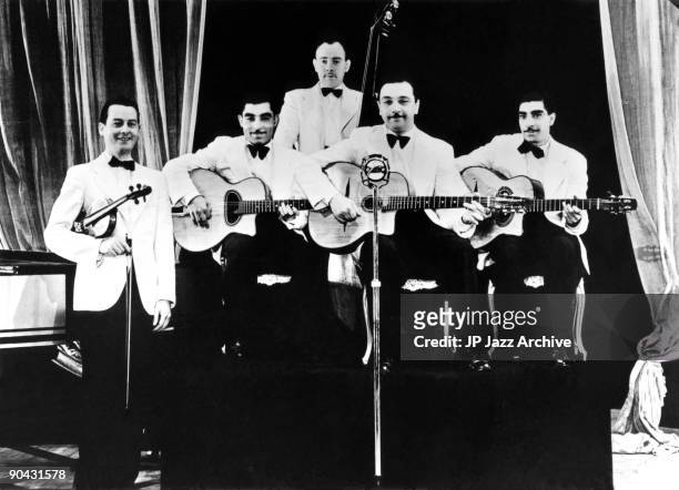 Django Reinhardt and Le Quintette du Hot Club de France pose for a group shot in 1939, Stephan Grappelli, Eugene Vees, Roger Grasset, Django...