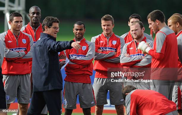 Fabio Capello talks to Frank Lampard, Carlton Cole, Ashley Cole, David Beckham, Wayne Rooney and the rest of the squad during the England training...