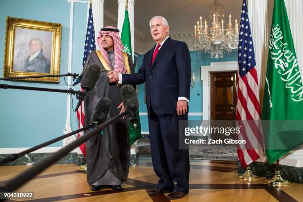 Secretary of State Rex Tillerson and Saudi Arabian Foreign Minister Adel al-Jubeir shake hands during a press event at the State Department on...