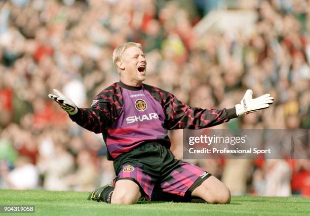 Peter Schmeichel of Manchester United sinks to his knees in celebration as teammate David Beckham scores the only goal of the game during the FA...