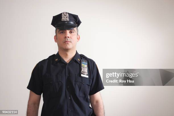 portrait of hispanic police officer - uniforme della polizia foto e immagini stock