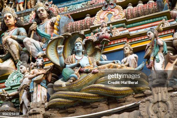 statue of shiva sitting on cobras on the gopura of the kapaleeswarar temple - sitting shiva stock pictures, royalty-free photos & images