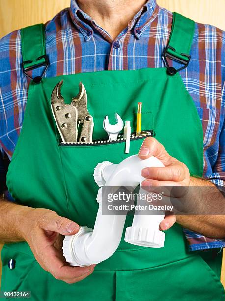 plumber with plastic u-bend pip and tools - u know stock pictures, royalty-free photos & images