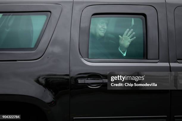 President Donald Trump waves to journalists as he leaves Walter Reed National Military Medical Center following his annual physical examination...