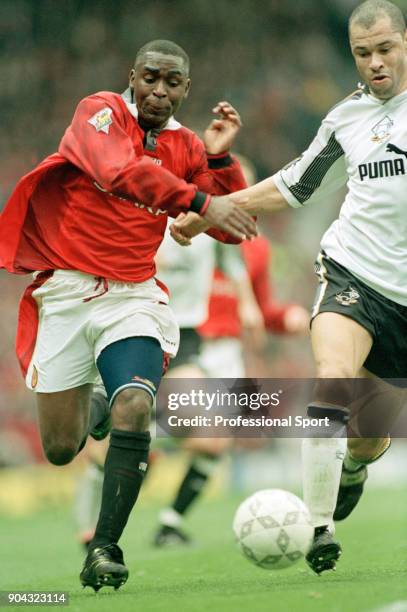 Andy Cole of Manchester United battles with Paul McGrath of Derby County during an FA Carling Premiership match at Old Trafford on April 05, 1997 in...