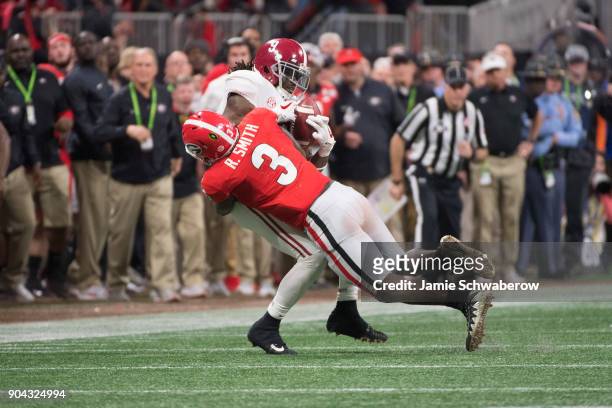 Bo Scarbrough of the Alabama Crimson Tide is tackles by Roquan Smith of the Georgia Bulldogs during the College Football Playoff National...