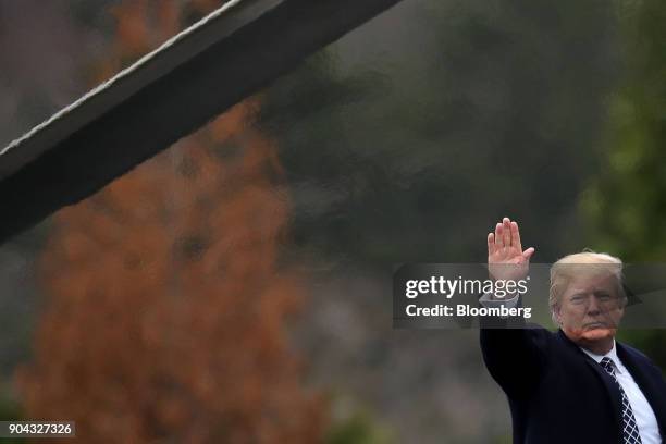 President Donald Trump waves to members of the media before boarding Marine One following his first medical exam at Walter Reed National Military...