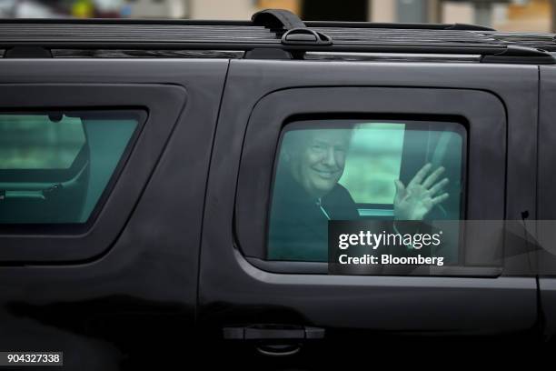 President Donald Trump waves to members of the media following his first medical exam at Walter Reed National Military Medical Center in Besthesda,...