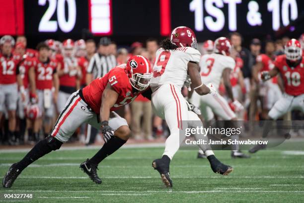 David Marshall of the Georgia Bulldogs tackles Bo Scarbrough of the Alabama Crimson Tide during the College Football Playoff National Championship...