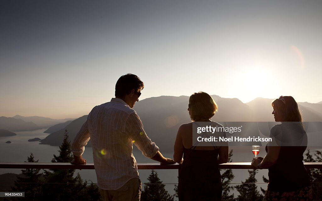 People socializing on deck, mountain view