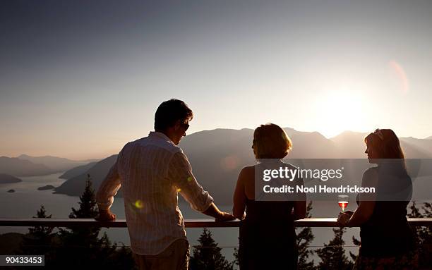 people socializing on deck, mountain view - howe sound stock pictures, royalty-free photos & images