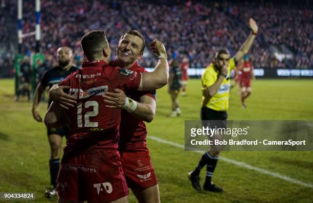 Scarlets Scott Williams celebrates scoring his side's fourth try with team mate Hadleigh Parkes during the European Rugby Champions Cup match between...