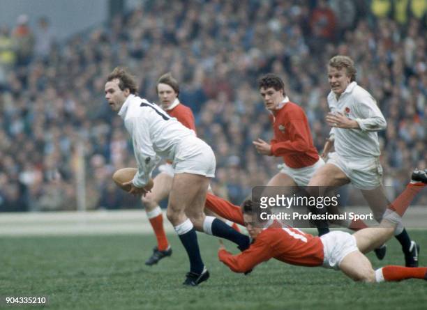 Clive Woodward of England evades a tackle from Bleddyn Bowen of Wales during the Five Nations rugby union match between England and Wales at...