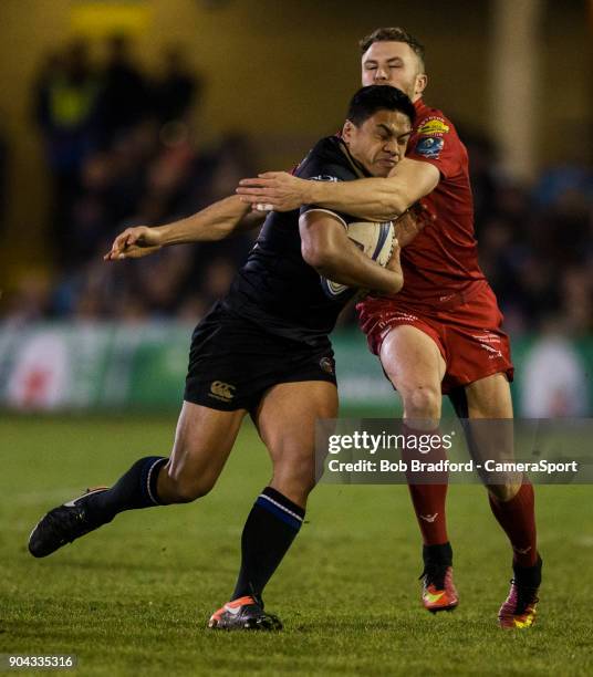 Bath Rugby's Ben Tapuai is tackled by Scarlets Tom Prydie during the European Rugby Champions Cup match between Bath Rugby and Scarlets at Recreation...