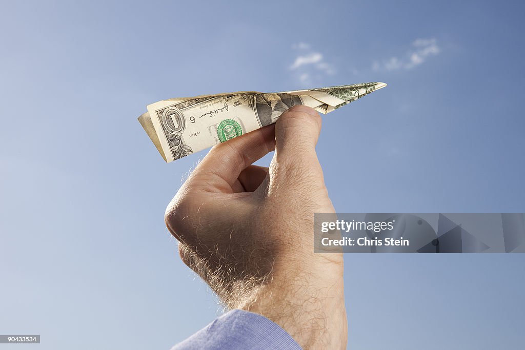 Man holding money airplane