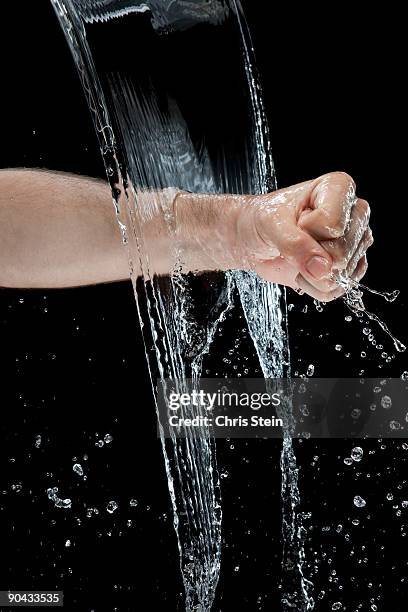 man punching through water - hand punching stock pictures, royalty-free photos & images