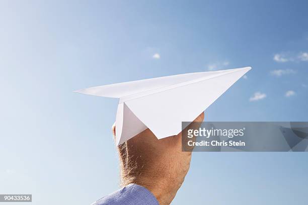 man with a paper airplane - paper airplane stock pictures, royalty-free photos & images