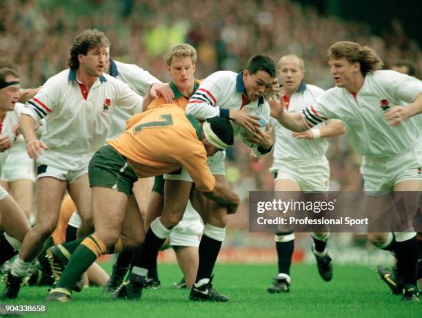 Rory Underwood of England is tackled by Willie Ofahengane of Australia during the Rugby Union World Cup Final at Twickenham in London on 2nd November...