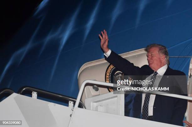 President Donald Trump steps off Air Force One upon arrival at Palm Beach International Airport in West Palm Beach, Florida on January 12, 2018. -...