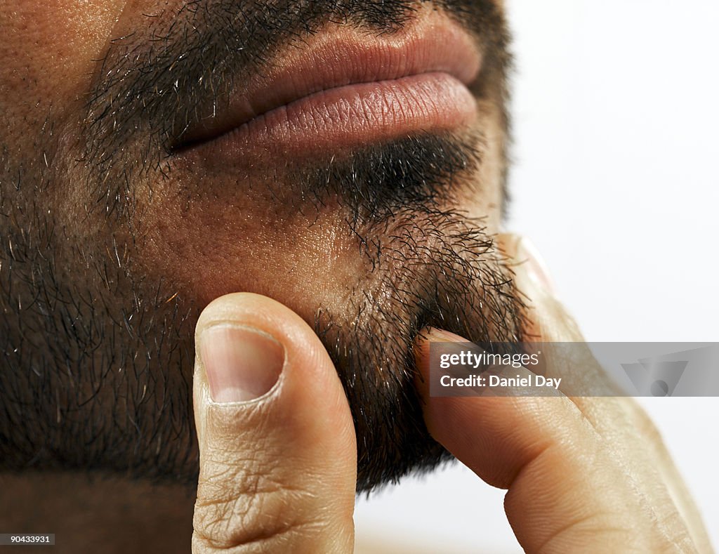 Man pinching chin