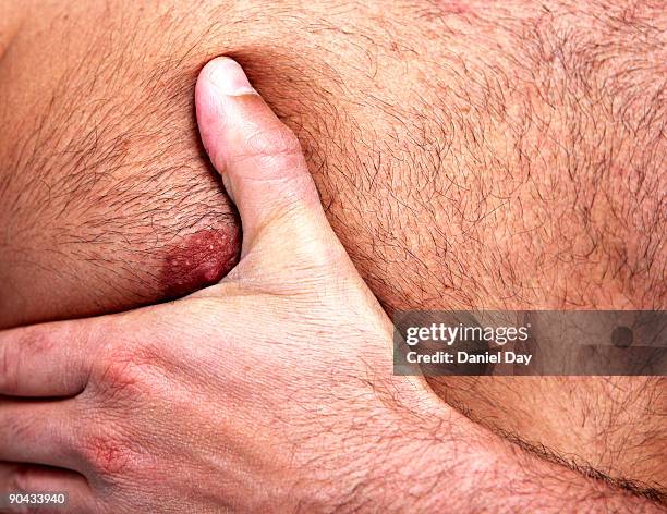 man with hand on chest - brustwarze stock-fotos und bilder