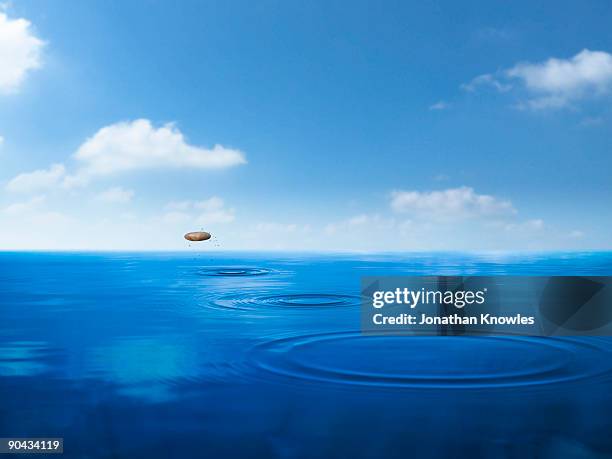 stone skimming off water - skimming stones stock pictures, royalty-free photos & images