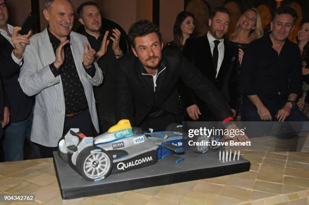 Orlando Bloom poses with his birthday cake as father Colin Stone and friends Scott Campbell, Andres Faucher and FIA Formula E CEO Alejandro Agag look...