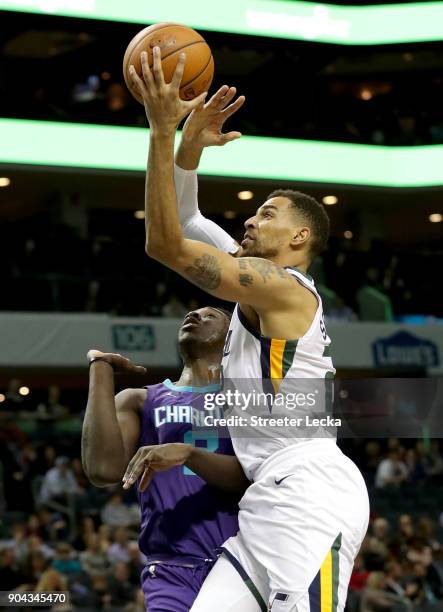 Thabo Sefolosha of the Utah Jazz drives to the basket against Johnny O'Bryant III of the Charlotte Hornets during their game at Spectrum Center on...