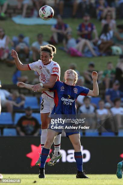 Emma Checker of Adelaide United contests the ball against Cortnee Vine of the Jets during the round 11 W-League match between the Newcastle Jets and...