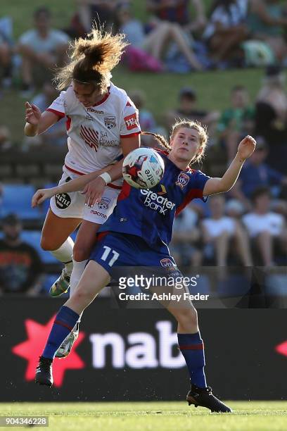 Emma Checker of Adelaide United contests the ball against Cortnee Vine of the Jets during the round 11 W-League match between the Newcastle Jets and...